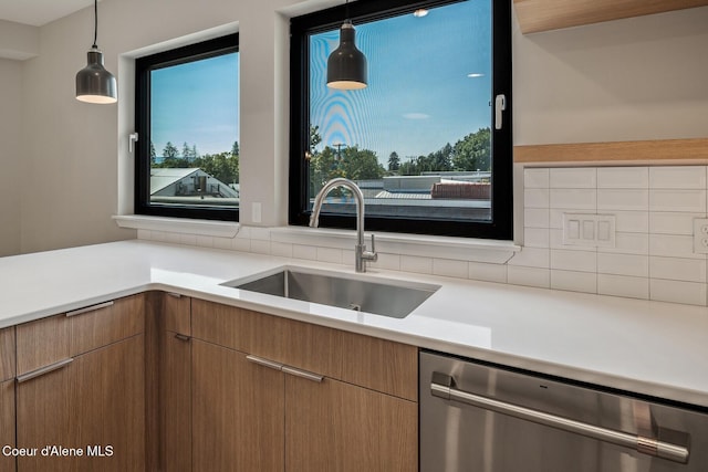 503 Cedar St # 203, Sandpoint, ID 83864 - kitchen with stainless steel dishwasher, decorative backsplash, light countertops, and pendant lighting