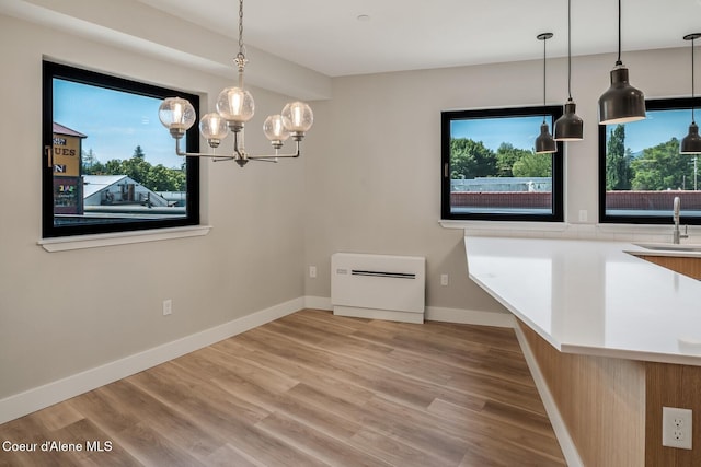 503 Cedar St # 203, Sandpoint, ID 83864 - unfurnished dining area with a chandelier and wood finished floors