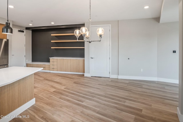 503 Cedar St # 203, Sandpoint, ID 83864 - unfurnished dining area with a chandelier, light wood-style flooring, and recessed lighting