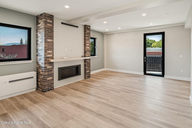 503 Cedar St # 203, Sandpoint, ID 83864 - unfurnished living room featuring a fireplace, light wood-type flooring, and recessed lighting