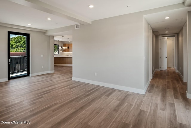 503 Cedar St # 203, Sandpoint, ID 83864 - empty room featuring a chandelier, light wood finished floors, and recessed lighting