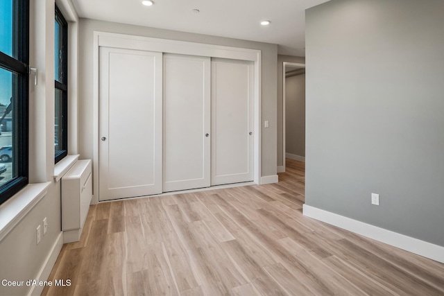 503 Cedar St # 203, Sandpoint, ID 83864 - unfurnished bedroom with a closet, light wood-style floors, and recessed lighting