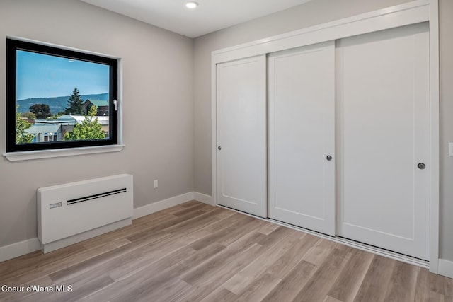 503 Cedar St # 203, Sandpoint, ID 83864 - unfurnished bedroom with a closet, light wood-type flooring, and recessed lighting