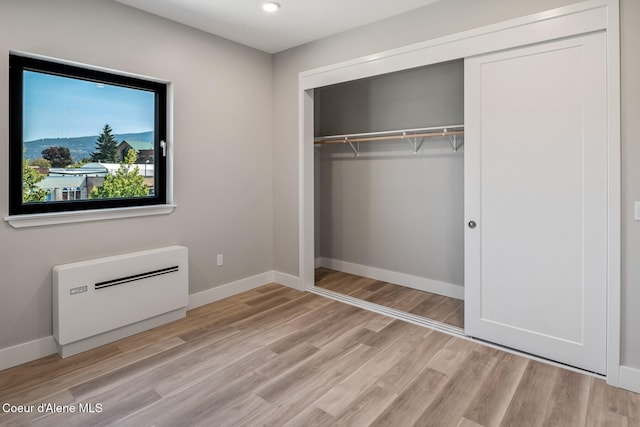 503 Cedar St # 203, Sandpoint, ID 83864 - unfurnished bedroom with a closet, light wood-style floors, and recessed lighting