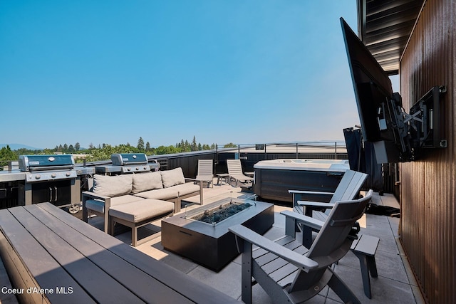 503 Cedar St # 203, Sandpoint, ID 83864 - deck featuring a hot tub, area for grilling, an outdoor living space with a fire pit, and a patio