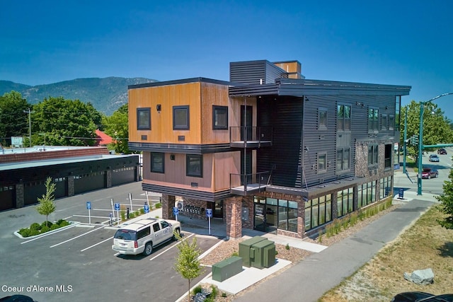 503 Cedar St # 203, Sandpoint, ID 83864 - view of property with uncovered parking and a mountain view