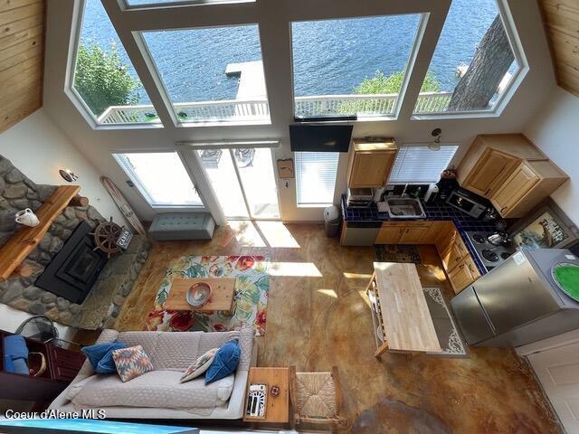 5734 W Freeman Rd, Rathdrum, ID 83858 - living area with a towering ceiling, healthy amount of natural light, a water view, and a fireplace