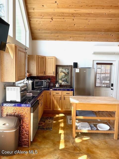 5734 W Freeman Rd, Rathdrum, ID 83858 - kitchen featuring appliances with stainless steel finishes, wooden ceiling, high vaulted ceiling, and tile countertops