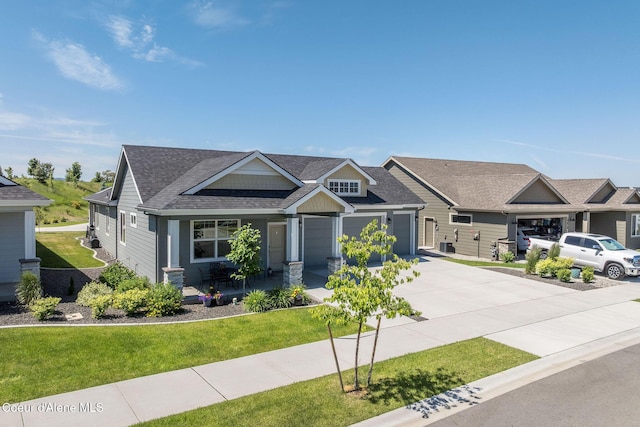 22830 E Bailey Ct, Liberty Lake, WA 99019 - craftsman-style home featuring driveway, a front yard, a porch, a garage, and roof with shingles