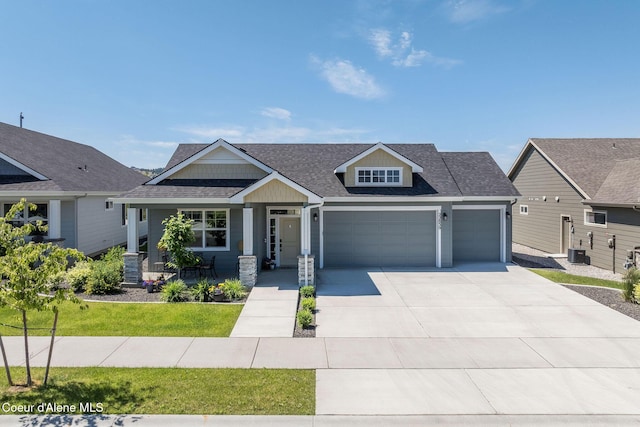 22830 E Bailey Ct, Liberty Lake, WA 99019 - craftsman inspired home featuring a garage, roof with shingles, driveway, a porch, and a front yard