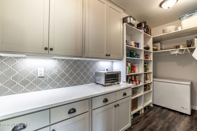 22830 E Bailey Ct, Liberty Lake, WA 99019 - kitchen featuring refrigerator, open shelves, dark wood finished floors, and tasteful backsplash