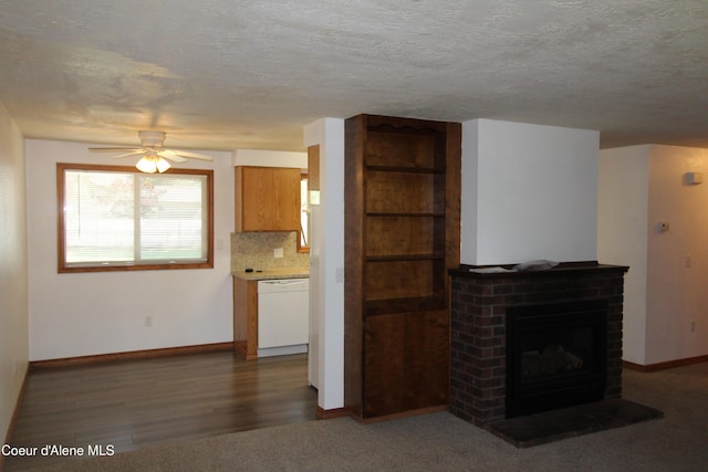 807809 E Timber Ln, Coeur Dalene, ID 83814 - unfurnished living room with ceiling fan, a textured ceiling, a fireplace, and wood finished floors