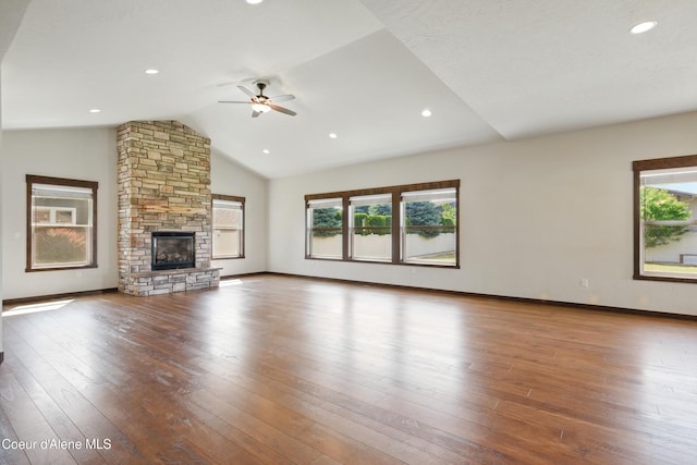 6984 W Blacktail Ave, Rathdrum, ID 83858 - unfurnished living room featuring a ceiling fan, healthy amount of natural light, vaulted ceiling, a fireplace, and hardwood / wood-style floors
