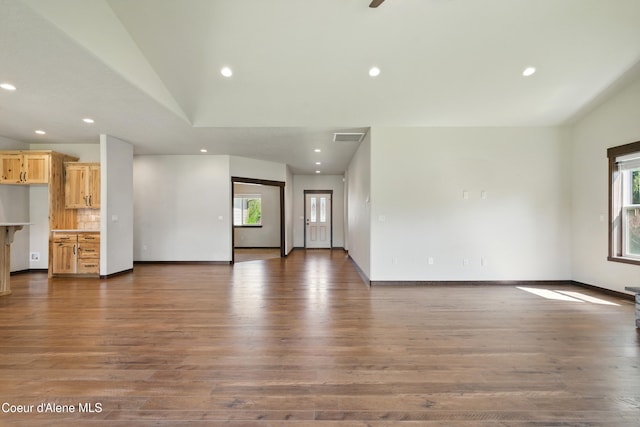 6984 W Blacktail Ave, Rathdrum, ID 83858 - unfurnished living room featuring wood finished floors, recessed lighting, and lofted ceiling