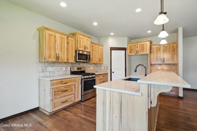 6984 W Blacktail Ave, Rathdrum, ID 83858 - kitchen featuring appliances with stainless steel finishes, dark wood-type flooring, tasteful backsplash, recessed lighting, and light brown cabinets