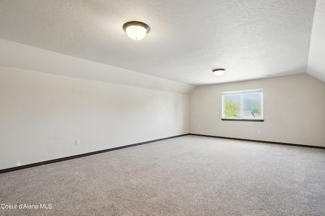 6984 W Blacktail Ave, Rathdrum, ID 83858 - carpeted empty room with lofted ceiling and a textured ceiling