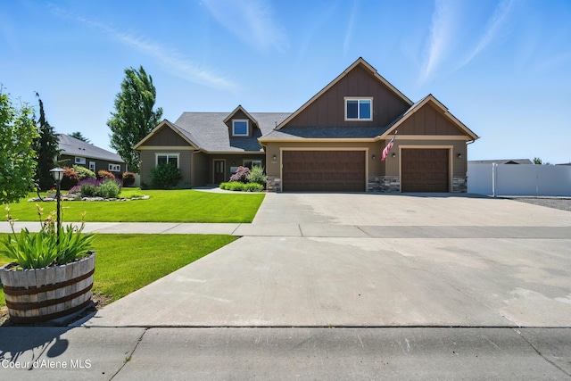 6984 W Blacktail Ave, Rathdrum, ID 83858 - craftsman-style home with board and batten siding, driveway, stone siding, and an attached garage