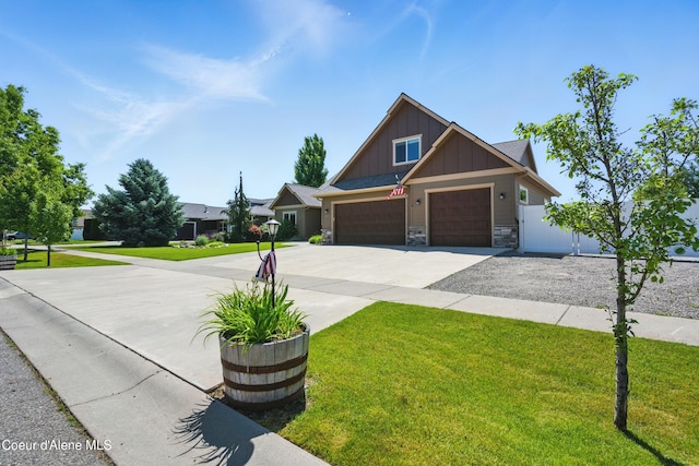 6984 W Blacktail Ave, Rathdrum, ID 83858 - craftsman house featuring board and batten siding, stone siding, driveway, and a garage