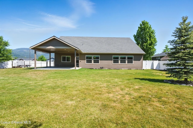 6984 W Blacktail Ave, Rathdrum, ID 83858 - back of house with a patio area, an attached carport, and a fenced backyard