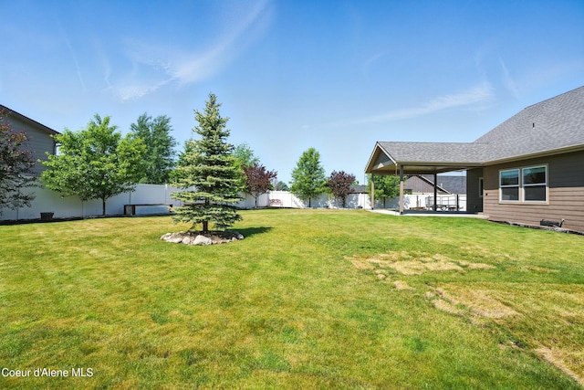 6984 W Blacktail Ave, Rathdrum, ID 83858 - fenced backyard featuring a patio