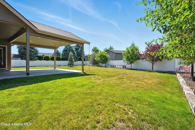 6984 W Blacktail Ave, Rathdrum, ID 83858 - fenced backyard with a patio area