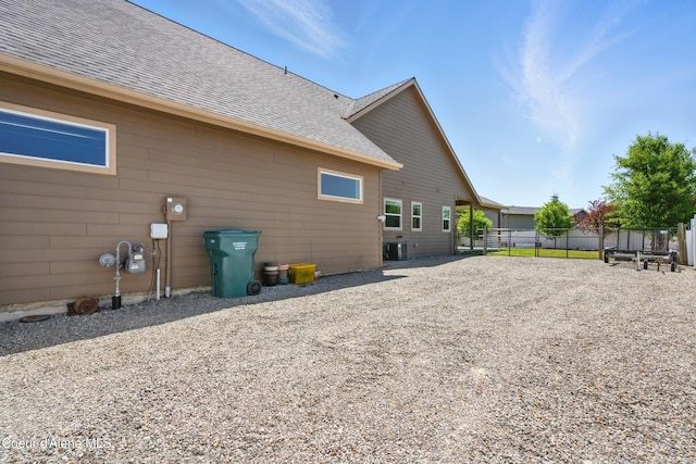 6984 W Blacktail Ave, Rathdrum, ID 83858 - back of house featuring a shingled roof and driveway