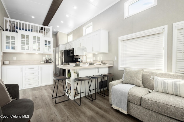 716 Raeder St, Kooskia, ID 83539 - kitchen with a breakfast bar, crown molding, appliances with stainless steel finishes, white cabinets, and a towering ceiling