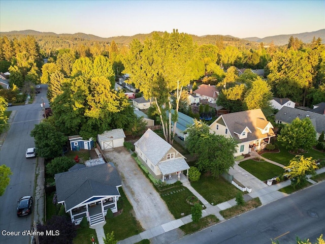 928 N 7th St, Coeur Dalene, ID 83814 - aerial perspective of suburban area featuring a heavily wooded area and a mountainous background