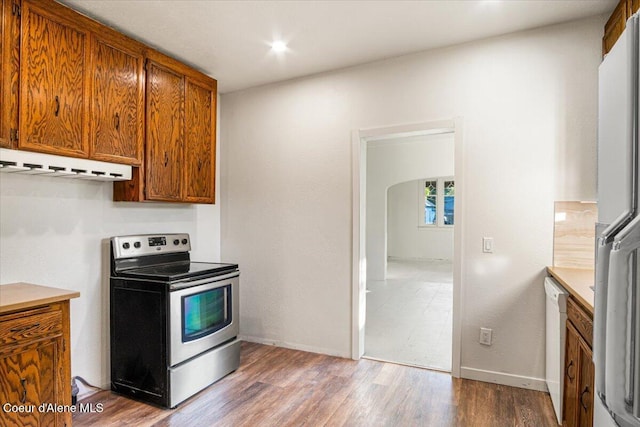 928 N 7th St, Coeur Dalene, ID 83814 - kitchen featuring electric stove, wood finished floors, brown cabinetry, dishwasher, and light countertops