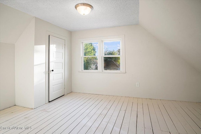 928 N 7th St, Coeur Dalene, ID 83814 - additional living space featuring light wood-style floors, lofted ceiling, and a textured ceiling
