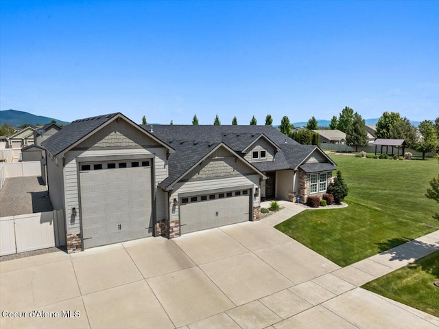 3265 E Galway Cir, Post Falls, ID 83854 - craftsman-style home featuring stone siding, driveway, an attached garage, and a shingled roof