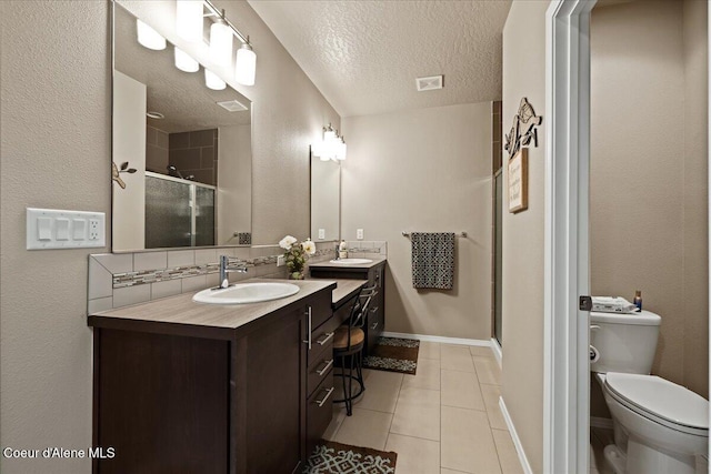 3265 E Galway Cir, Post Falls, ID 83854 - full bathroom featuring a shower stall, double vanity, tile patterned floors, and a textured ceiling