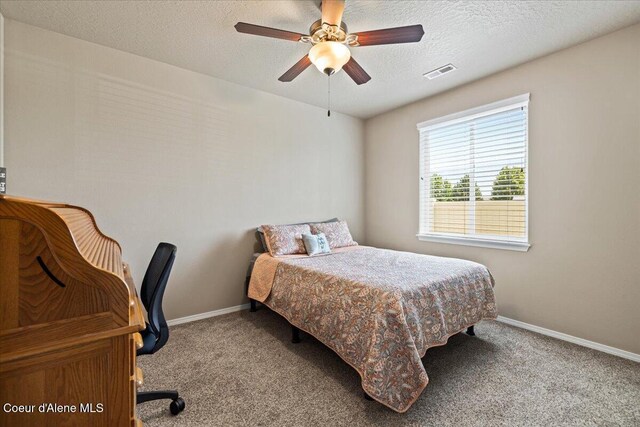 3265 E Galway Cir, Post Falls, ID 83854 - bedroom featuring carpet floors, an office area, a textured ceiling, and a ceiling fan