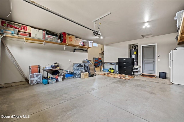 3265 E Galway Cir, Post Falls, ID 83854 - garage featuring freestanding refrigerator, a garage door opener, and water heater