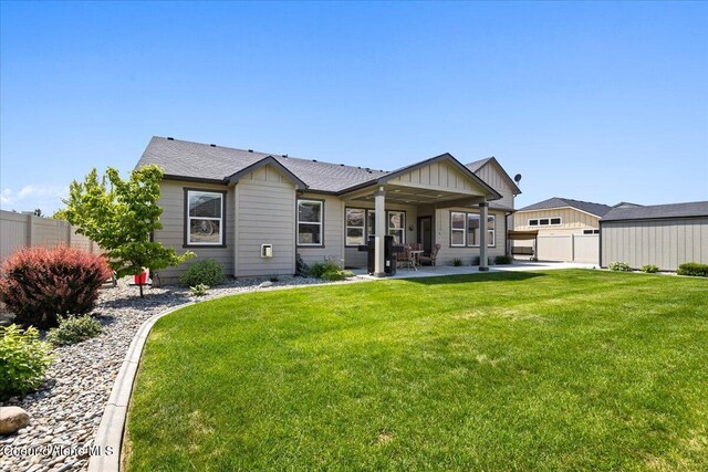 3265 E Galway Cir, Post Falls, ID 83854 - back of house with board and batten siding and a patio