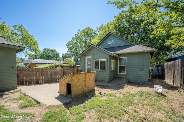 1901 E Pennsylvania Ave, Coeur Dalene, ID 83814 - back of property with roof with shingles and a patio