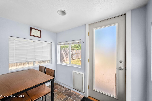 1901 E Pennsylvania Ave, Coeur Dalene, ID 83814 - dining space featuring stone finish flooring and a textured ceiling