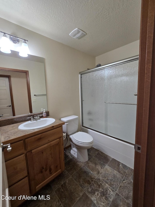 8706 W Sawtooth St, Rathdrum, ID 83858 - full bathroom with vanity, combined bath / shower with glass door, and a textured ceiling