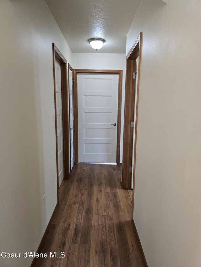 8706 W Sawtooth St, Rathdrum, ID 83858 - hallway featuring dark wood finished floors and a textured ceiling