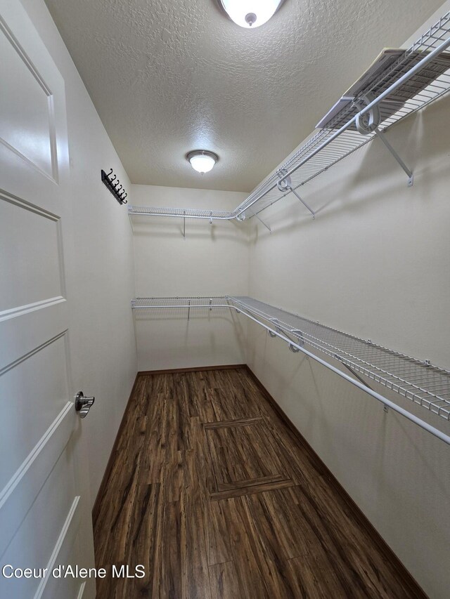 8706 W Sawtooth St, Rathdrum, ID 83858 - spacious closet featuring dark wood-type flooring