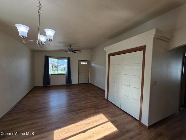 8706 W Sawtooth St, Rathdrum, ID 83858 - interior space with dark wood-style floors, a chandelier, ceiling fan, and arched walkways