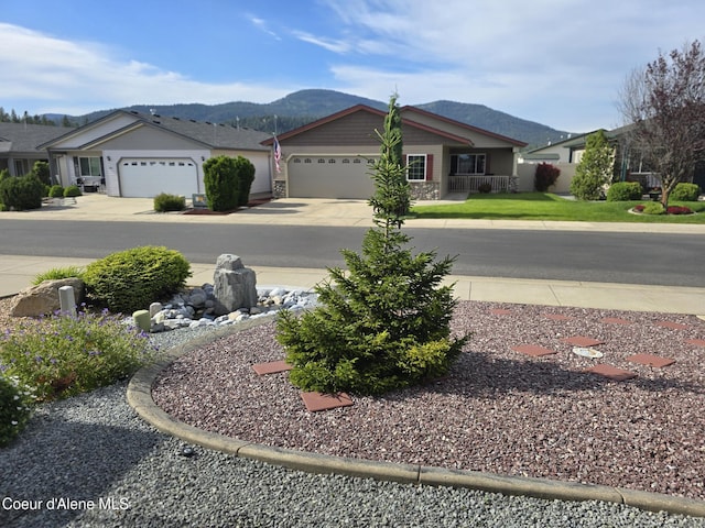 8706 W Sawtooth St, Rathdrum, ID 83858 - view of yard featuring a mountain view, driveway, and a garage