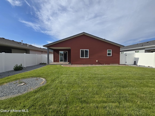 8706 W Sawtooth St, Rathdrum, ID 83858 - rear view of property with a fenced backyard and a gate