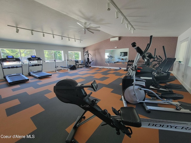 8706 W Sawtooth St, Rathdrum, ID 83858 - workout area featuring track lighting, vaulted ceiling, ceiling fan, a textured ceiling, and a wall unit AC