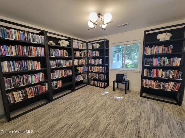 8706 W Sawtooth St, Rathdrum, ID 83858 - sitting room featuring wall of books and a chandelier