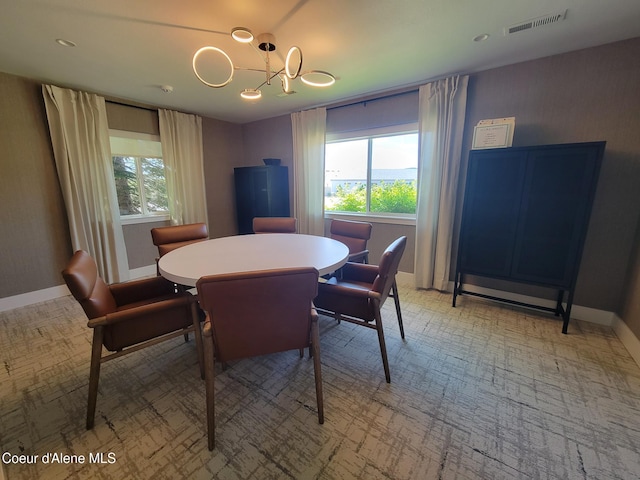 8706 W Sawtooth St, Rathdrum, ID 83858 - dining space featuring a chandelier and light colored carpet