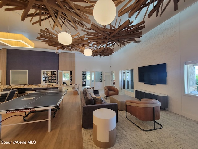8706 W Sawtooth St, Rathdrum, ID 83858 - recreation room with high vaulted ceiling, beamed ceiling, plenty of natural light, and wood finished floors