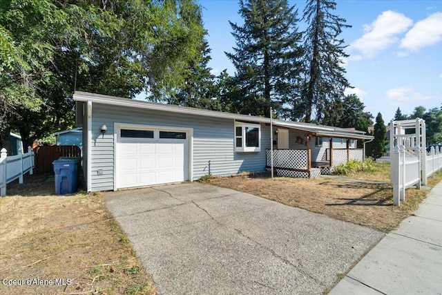 1038 N 15th St, Coeur Dalene, ID 83814 - view of front facade with asphalt driveway, an attached garage, and a porch