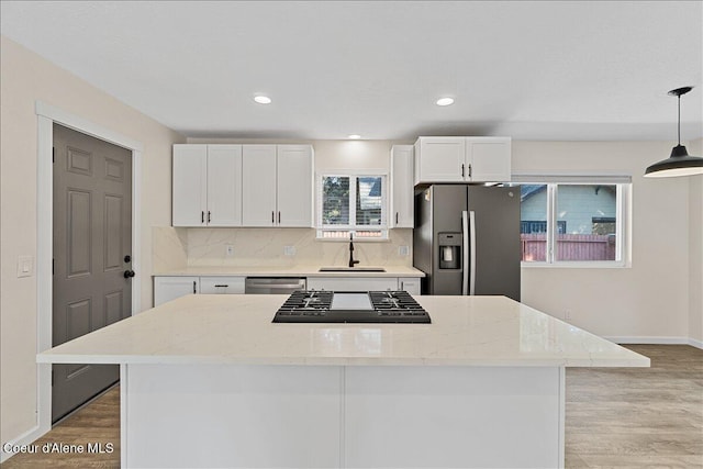1038 N 15th St, Coeur Dalene, ID 83814 - kitchen featuring stainless steel appliances, light wood-style floors, white cabinetry, decorative backsplash, and recessed lighting