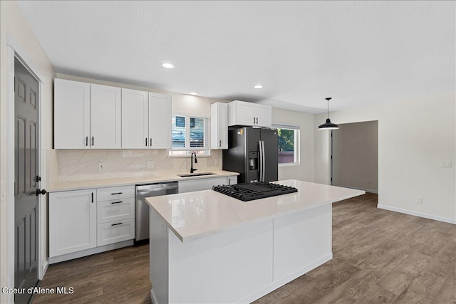 1038 N 15th St, Coeur Dalene, ID 83814 - kitchen featuring black appliances, white cabinets, a kitchen island, dark wood finished floors, and backsplash
